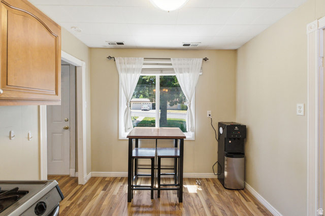 94 West 2000th Street North Clearfield, UT 84015 - Photo 11 of 26 Cozy dining area with front-facing window, warm flooring, and easy flow into the kitchen and living space.