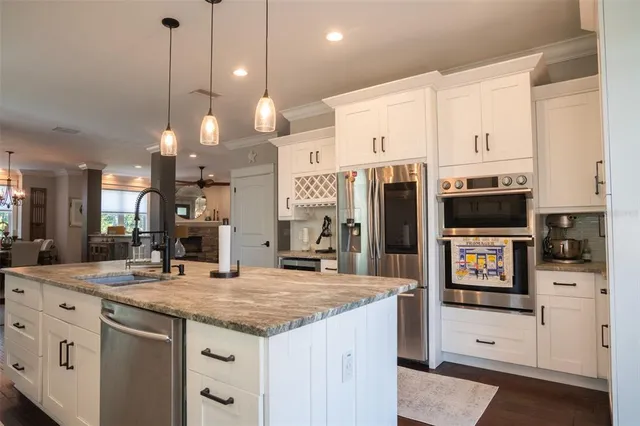 a view of a dining room with furniture a rug and wooden floor