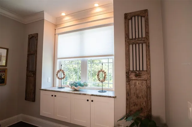 a living room with stainless steel appliances furniture a fireplace and a flat screen tv