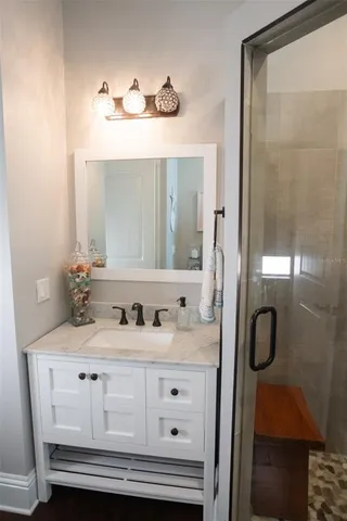 a view of a kitchen with wooden floor and electronic appliances
