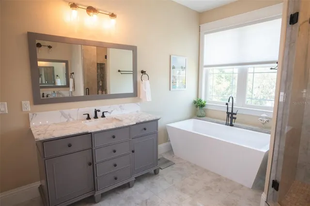 an aerial view of a house with garden space and street view