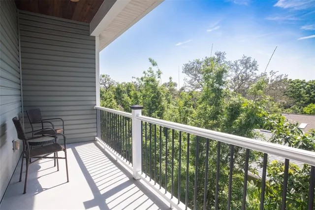 a view of a dining room with furniture a rug and wooden floor