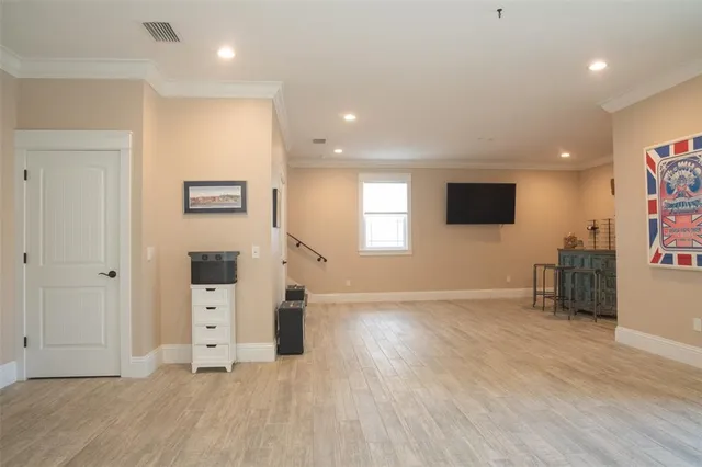 a white toilet sitting next to a white sink and vanity