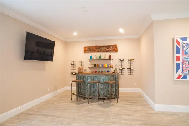 a dining room with furniture a chandelier and wooden floor