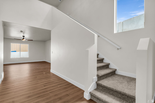 576 7th Avenue Midvale, UT 84047 - Photo 2 of 32 Staircase with ceiling fan and wood finished floors