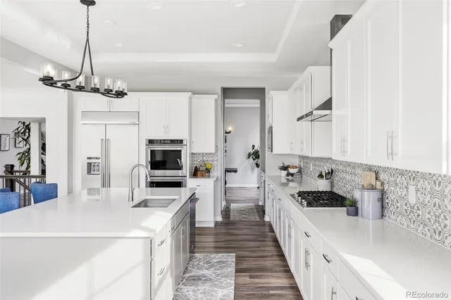 a kitchen with stainless steel appliances a stove sink and refrigerator