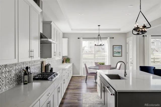 a kitchen with sink a stove and cabinets