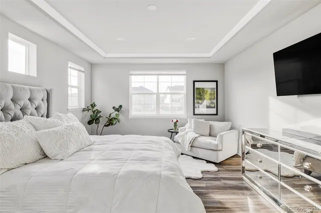 a bedroom with a large bed and a flat screen tv