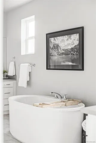 a bathroom with a bathtub and a window