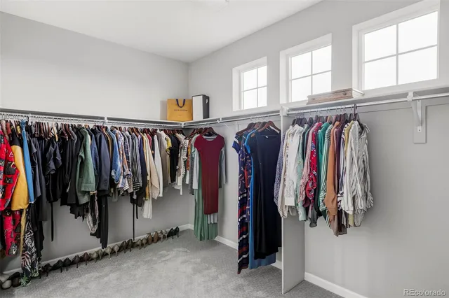 a view of walk in closet with clothes