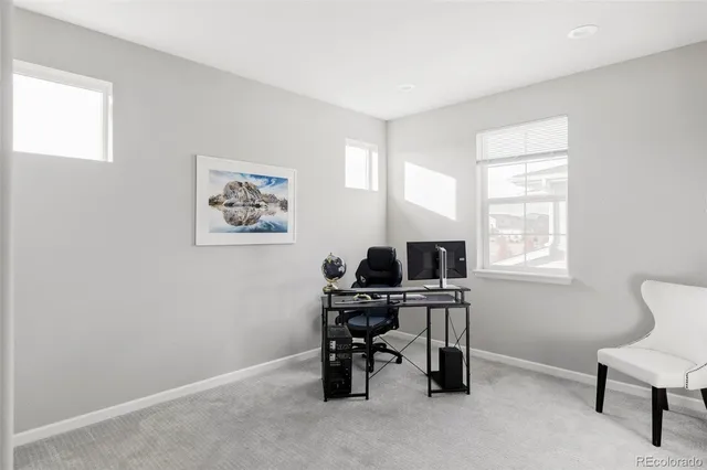 a bathroom with a granite countertop sink a toilet a mirror and shower