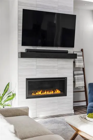 a living room with a fireplace and a flat screen tv