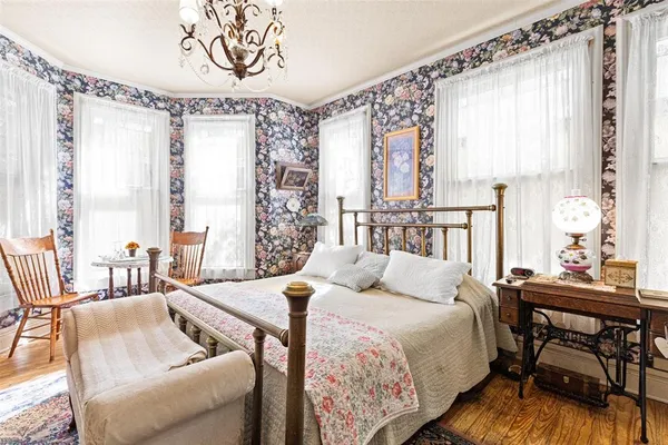 a bed room with a bed and a chandelier