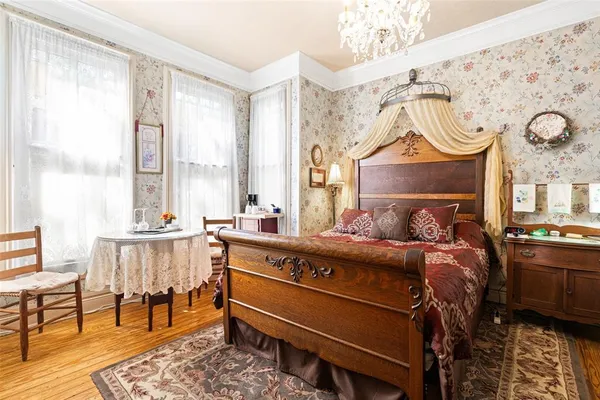 a bed room with a bed window and a chair