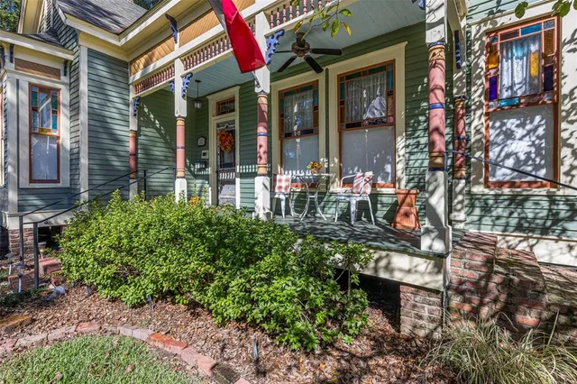 a view of a house with a tree in front of it