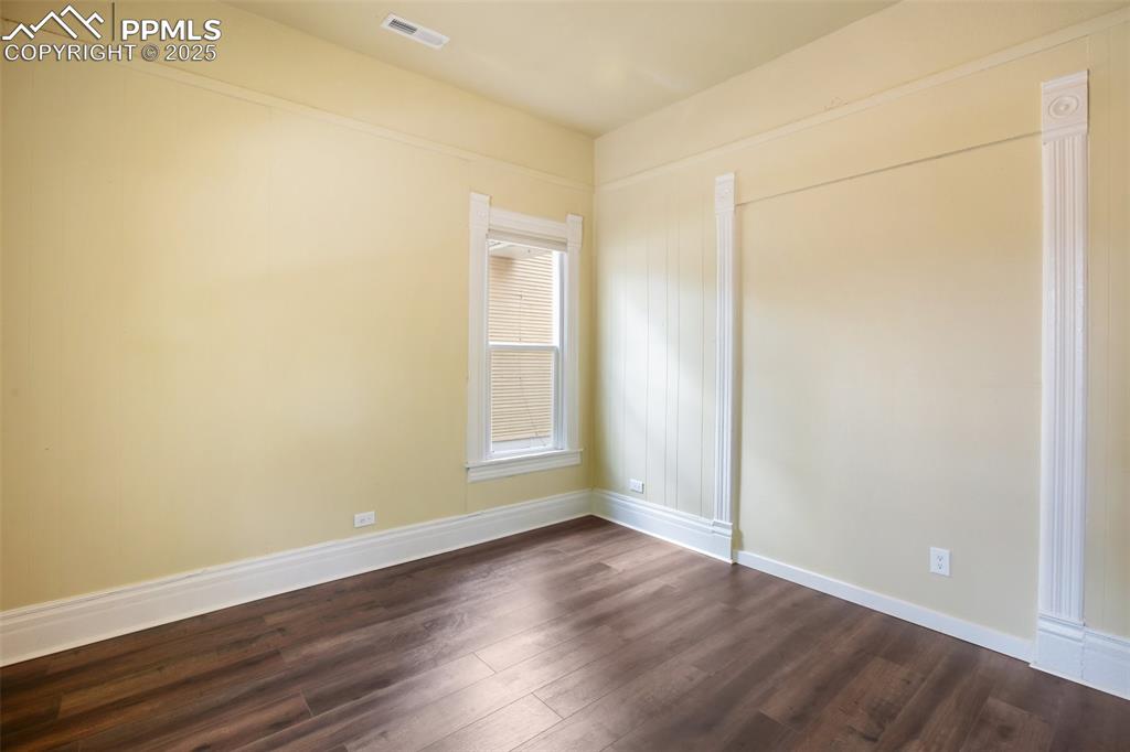 Undisclosed Address Pueblo, CO 81004 - Photo 11 of 23 an empty room with wooden floor and windows