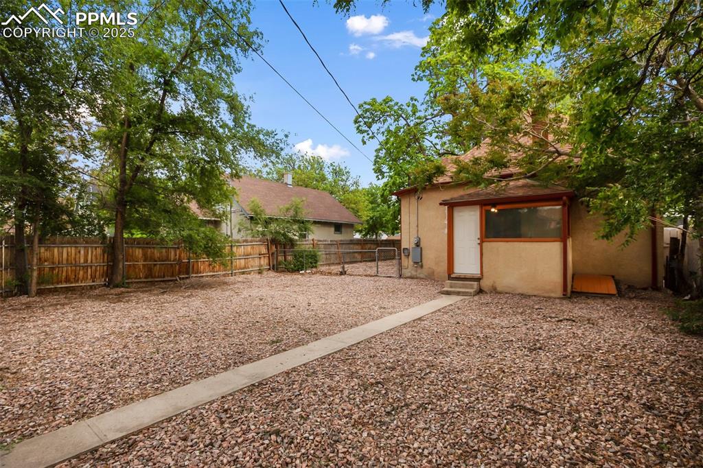 Undisclosed Address Pueblo, CO 81004 - Photo 21 of 23 a front view of a house with a yard and garage