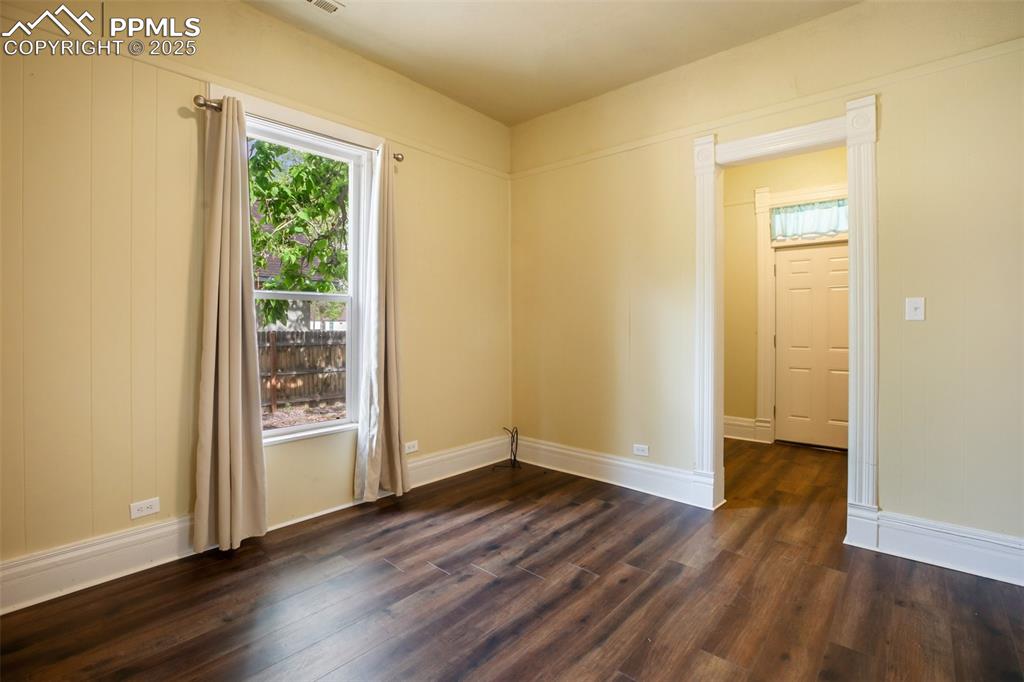 Undisclosed Address Pueblo, CO 81004 - Photo 3 of 23 an empty room with wooden floor and a window