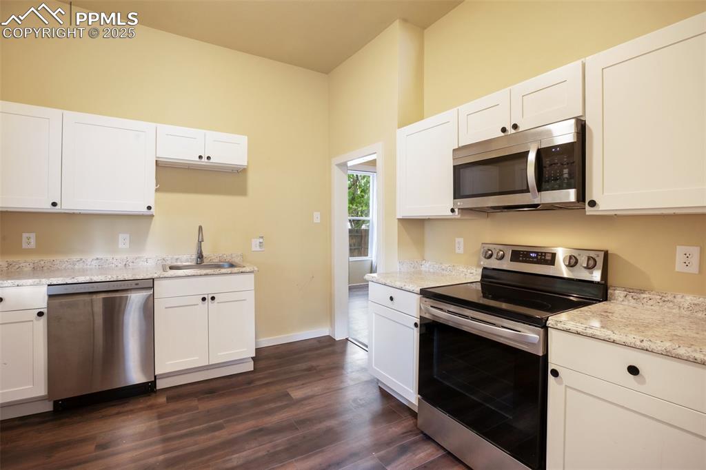 Undisclosed Address Pueblo, CO 81004 - Photo 5 of 23 a kitchen with granite countertop a sink cabinets and stainless steel appliances