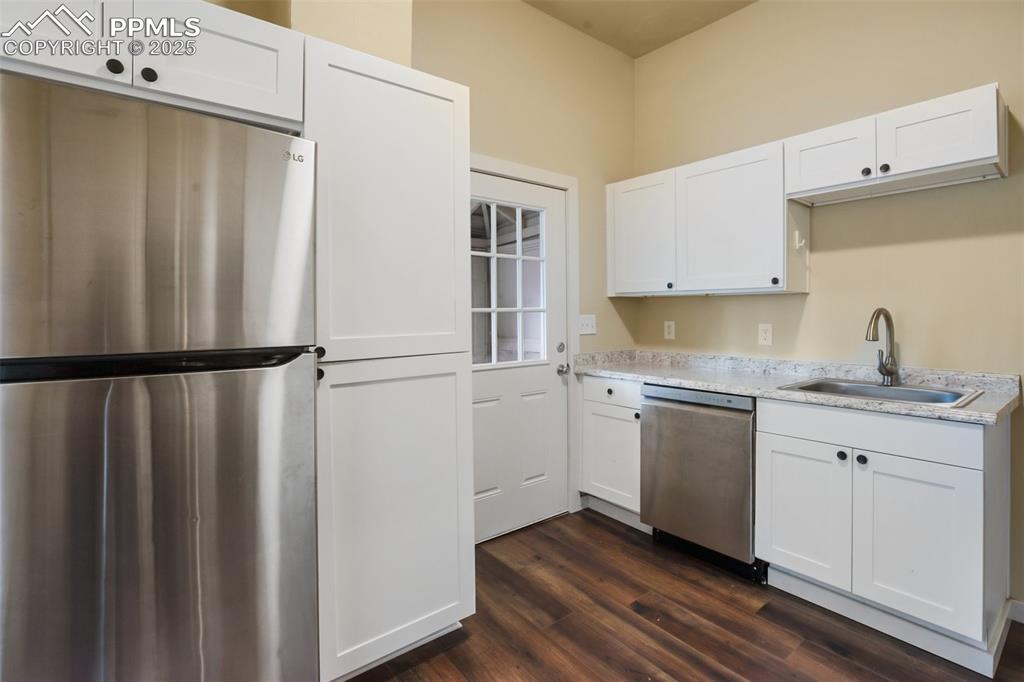 Undisclosed Address Pueblo, CO 81004 - Photo 7 of 23 a kitchen with granite countertop a refrigerator sink and cabinets
