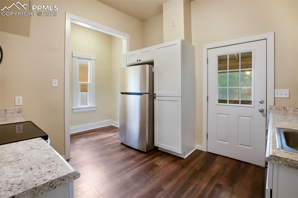 Undisclosed Address Pueblo, CO 81004 - Photo 8 of 23 a view of a kitchen with wooden floor and electronic appliances