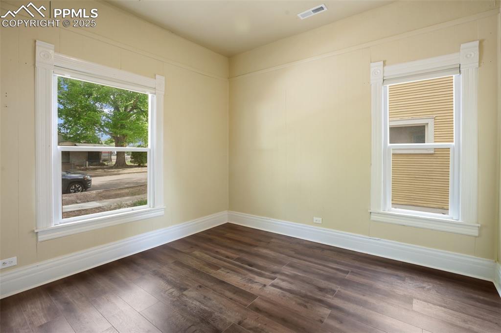 Undisclosed Address Pueblo, CO 81004 - Photo 10 of 23 an empty room with wooden floor and windows