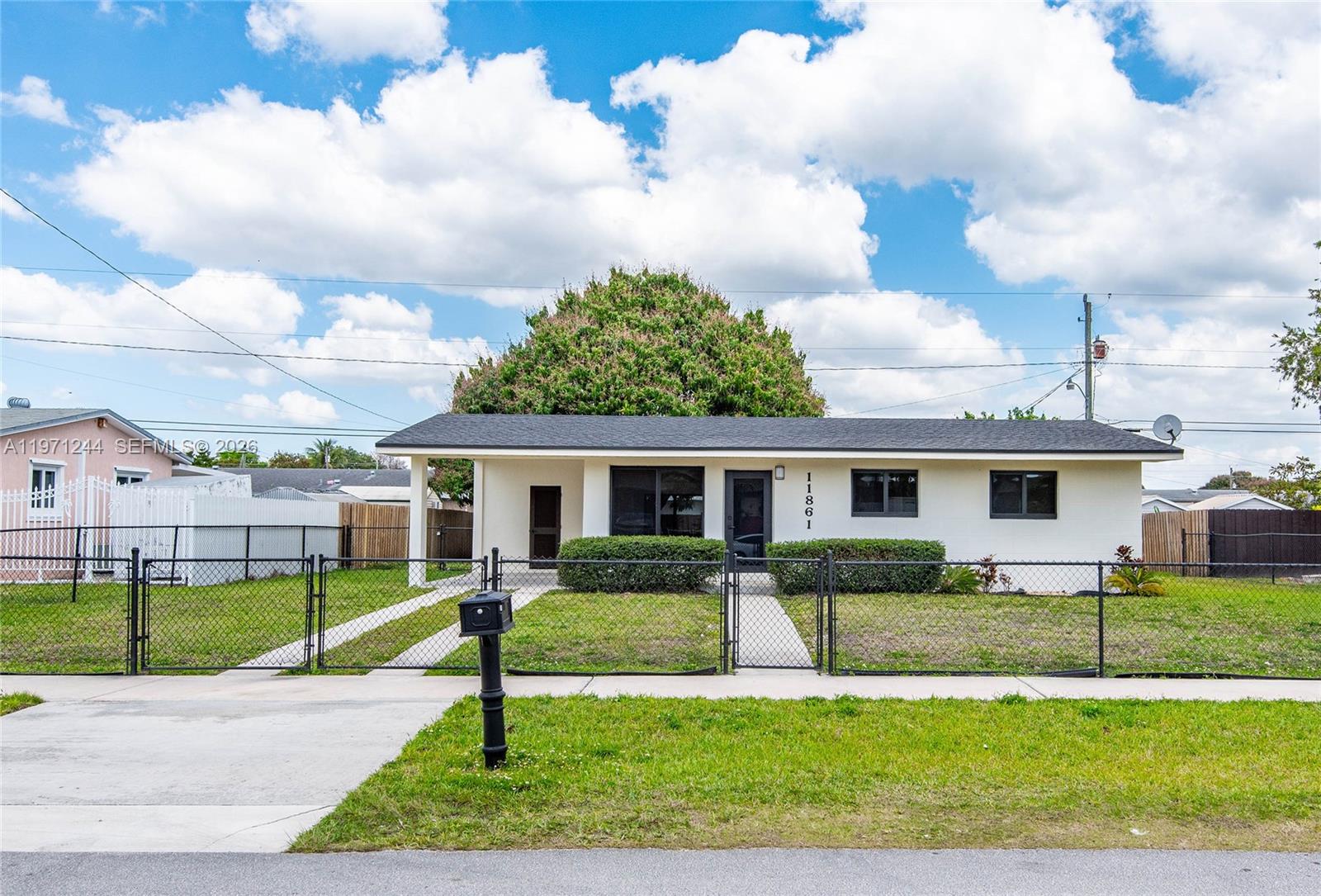 a view of a house with a yard in front of it