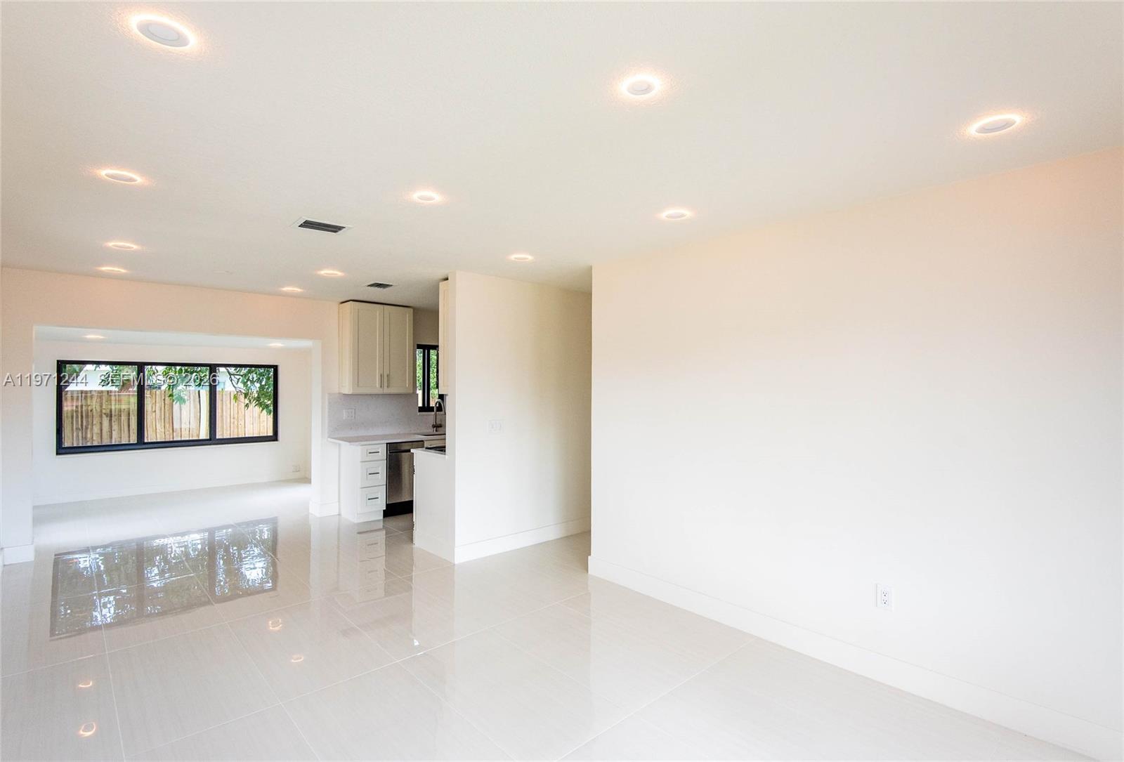 11861 Southwest 185th Terrace Miami, FL 33177 - Photo 13 of 34 a view of a living room kitchen with stainless steel appliances cabinets