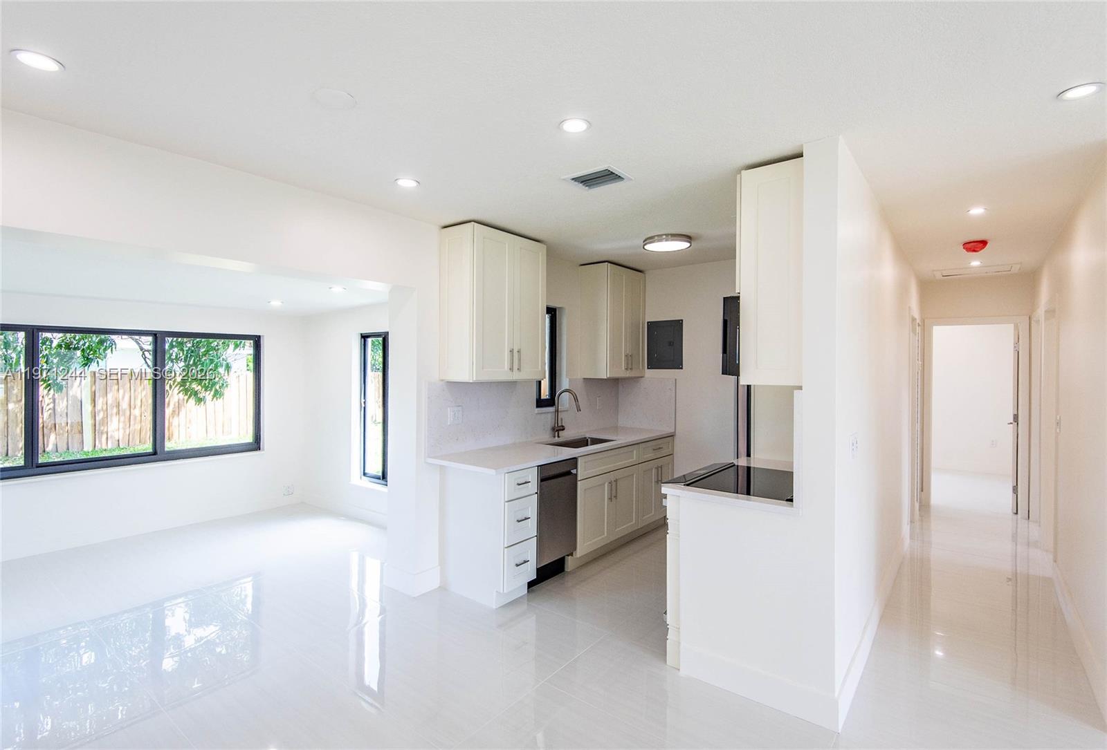 11861 Southwest 185th Terrace Miami, FL 33177 - Photo 16 of 34 a large kitchen with stainless steel appliances lots of counter space and a sink