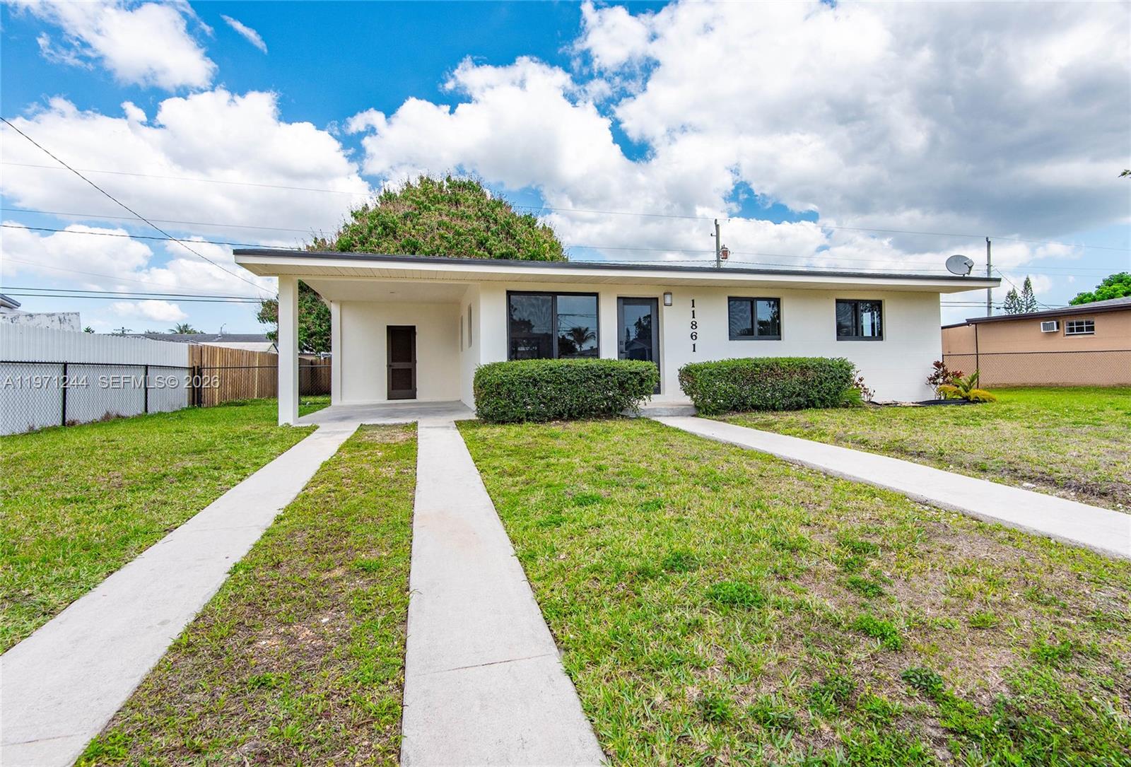 11861 Southwest 185th Terrace Miami, FL 33177 - Photo 2 of 34 a view of a house with a yard and potted plants