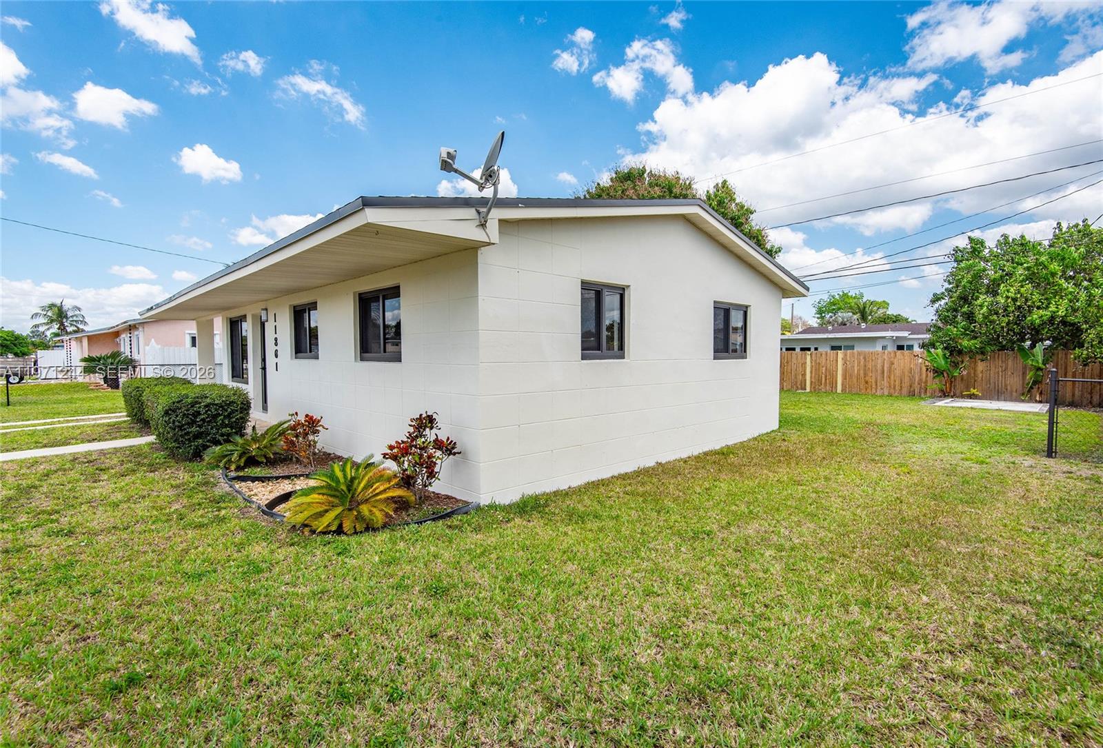 11861 Southwest 185th Terrace Miami, FL 33177 - Photo 4 of 34 a backyard of a house with table and chairs