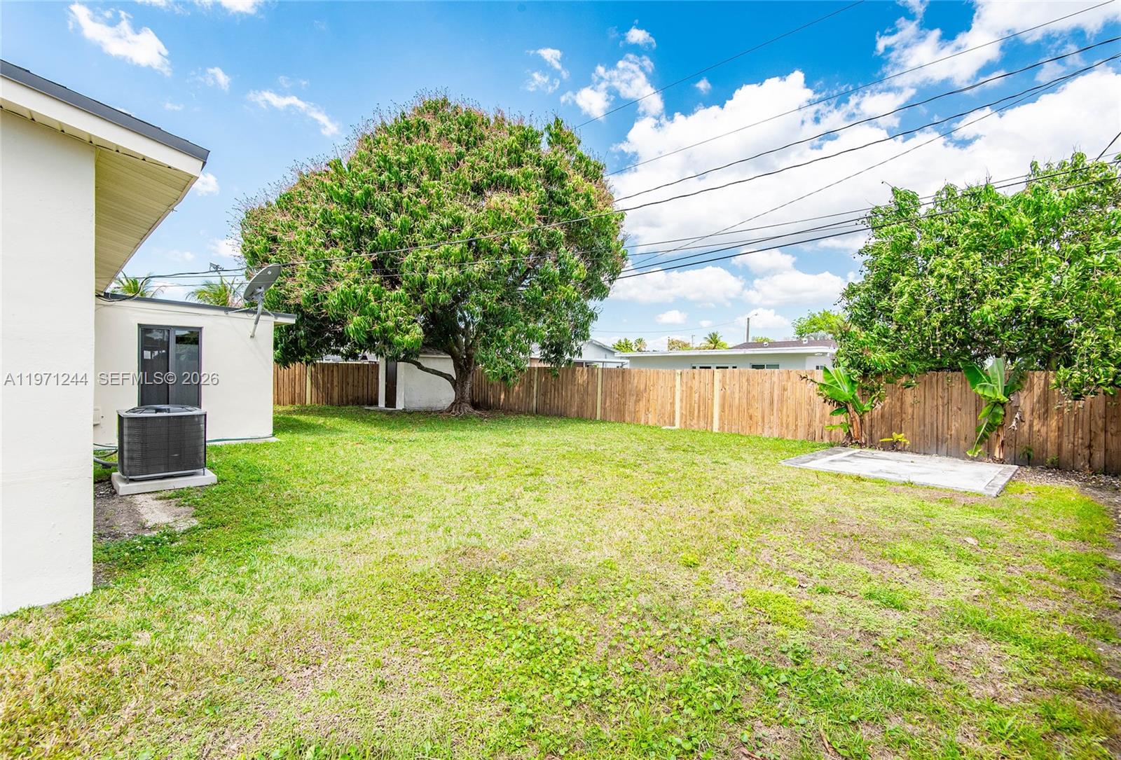11861 Southwest 185th Terrace Miami, FL 33177 - Photo 5 of 34 a view of a house with backyard and a tree