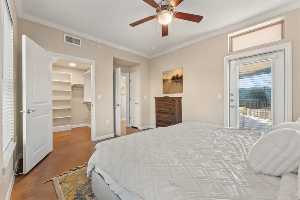a bedroom with a large bed and a chandelier
