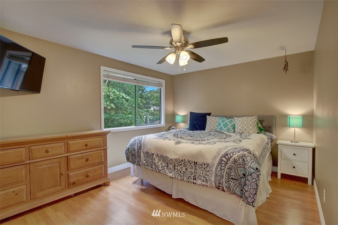 2227 Southeast 8th Place Renton, WA 98057 - Photo 14 of 21 a bedroom with a bed and a chandelier