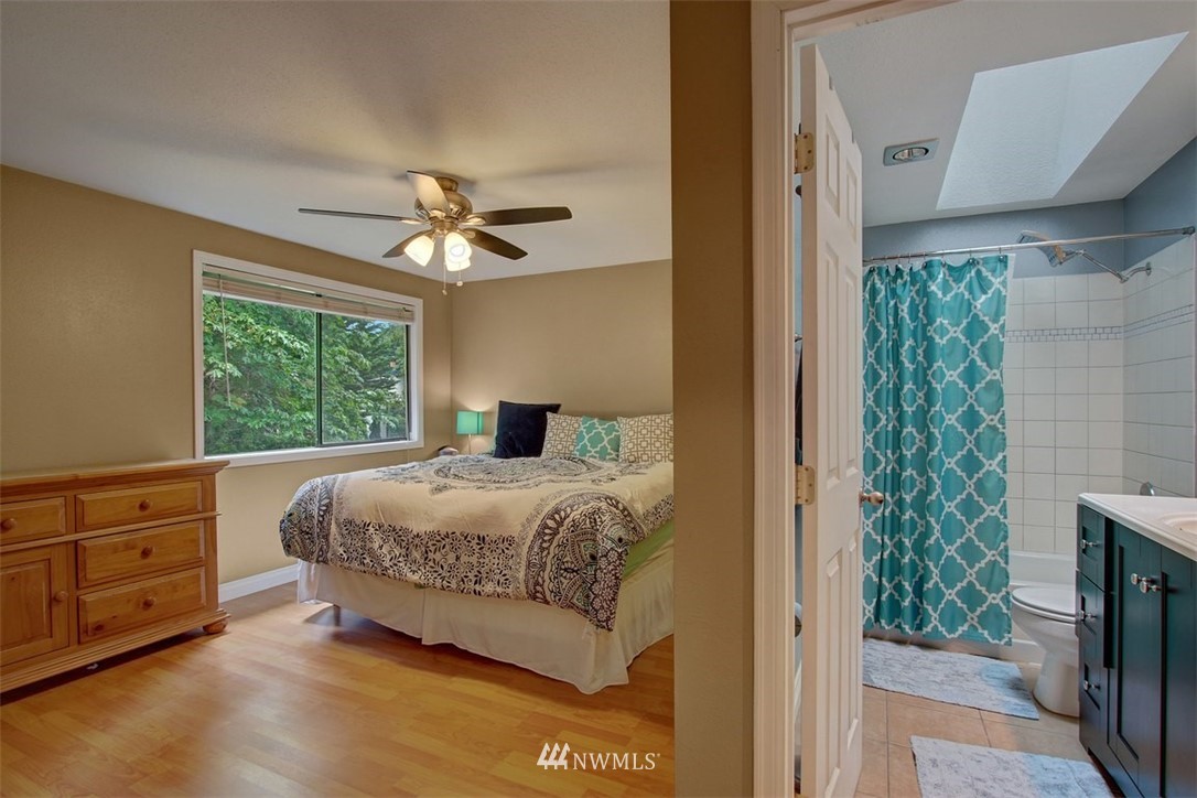 2227 Southeast 8th Place Renton, WA 98057 - Photo 15 of 21 a bedroom with a bed and a chandelier