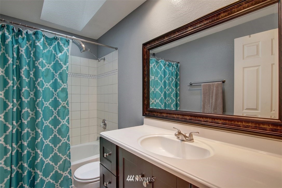 2227 Southeast 8th Place Renton, WA 98057 - Photo 16 of 21 a bathroom with a sink and a mirror