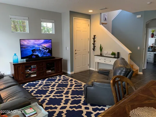 a living room with furniture and a flat screen tv