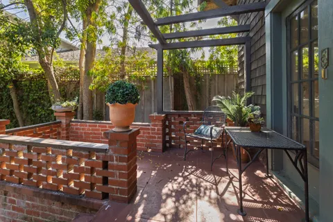 a view of a patio with table and chairs and potted plants