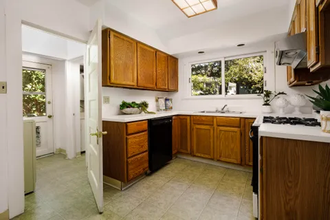 a kitchen with a sink stove and cabinets