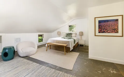 a bedroom with a bed and lamp