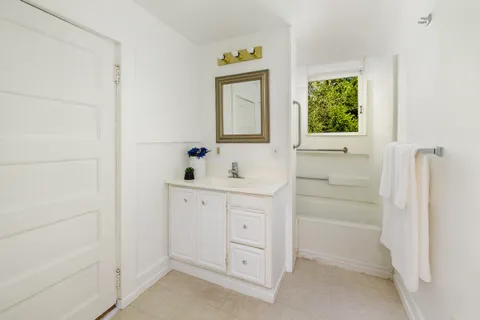 a bathroom with a sink a vanity and a window
