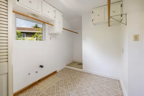 a white toilet sitting next to a bathroom sink and a window