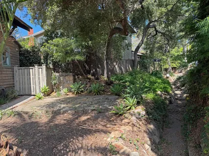 a view of backyard with table and chairs