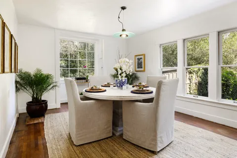 a view of a dining room with furniture window and wooden floor