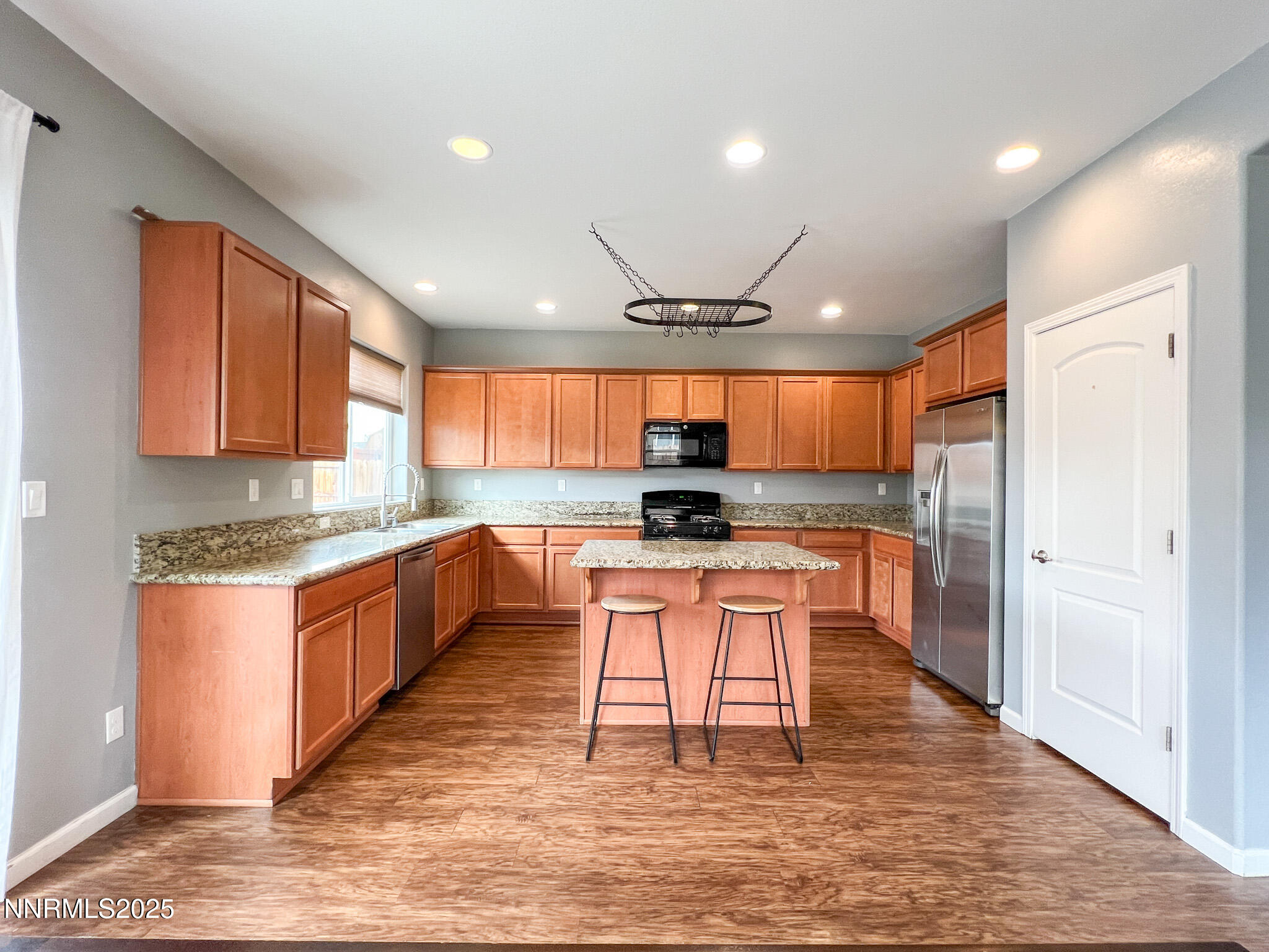 147 Walnut Drive Fernley, NV 89408 - Photo 11 of 31 a kitchen with stainless steel appliances granite countertop a refrigerator a sink dishwasher a stove and white cabinets with wooden floor