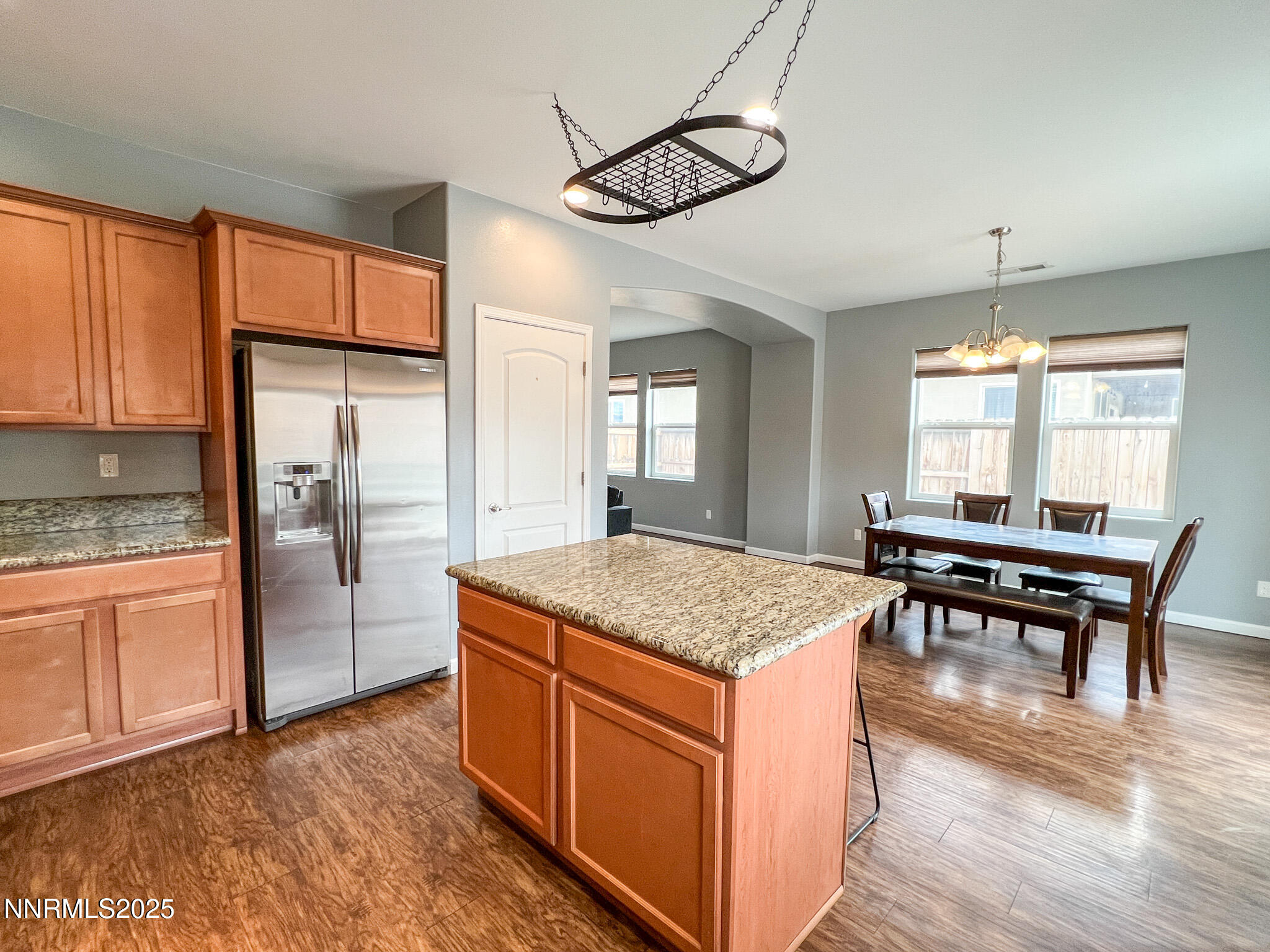 147 Walnut Drive Fernley, NV 89408 - Photo 14 of 31 a kitchen with stainless steel appliances granite countertop a stove a refrigerator a sink a dining table and chairs with wooden floor
