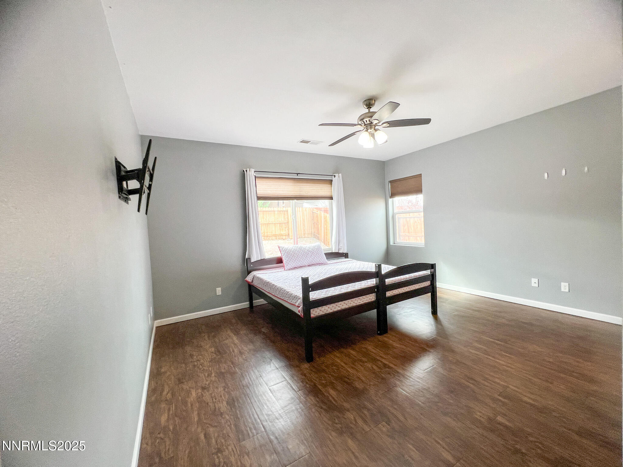 147 Walnut Drive Fernley, NV 89408 - Photo 15 of 31 a spacious bedroom with a bed and a chandelier