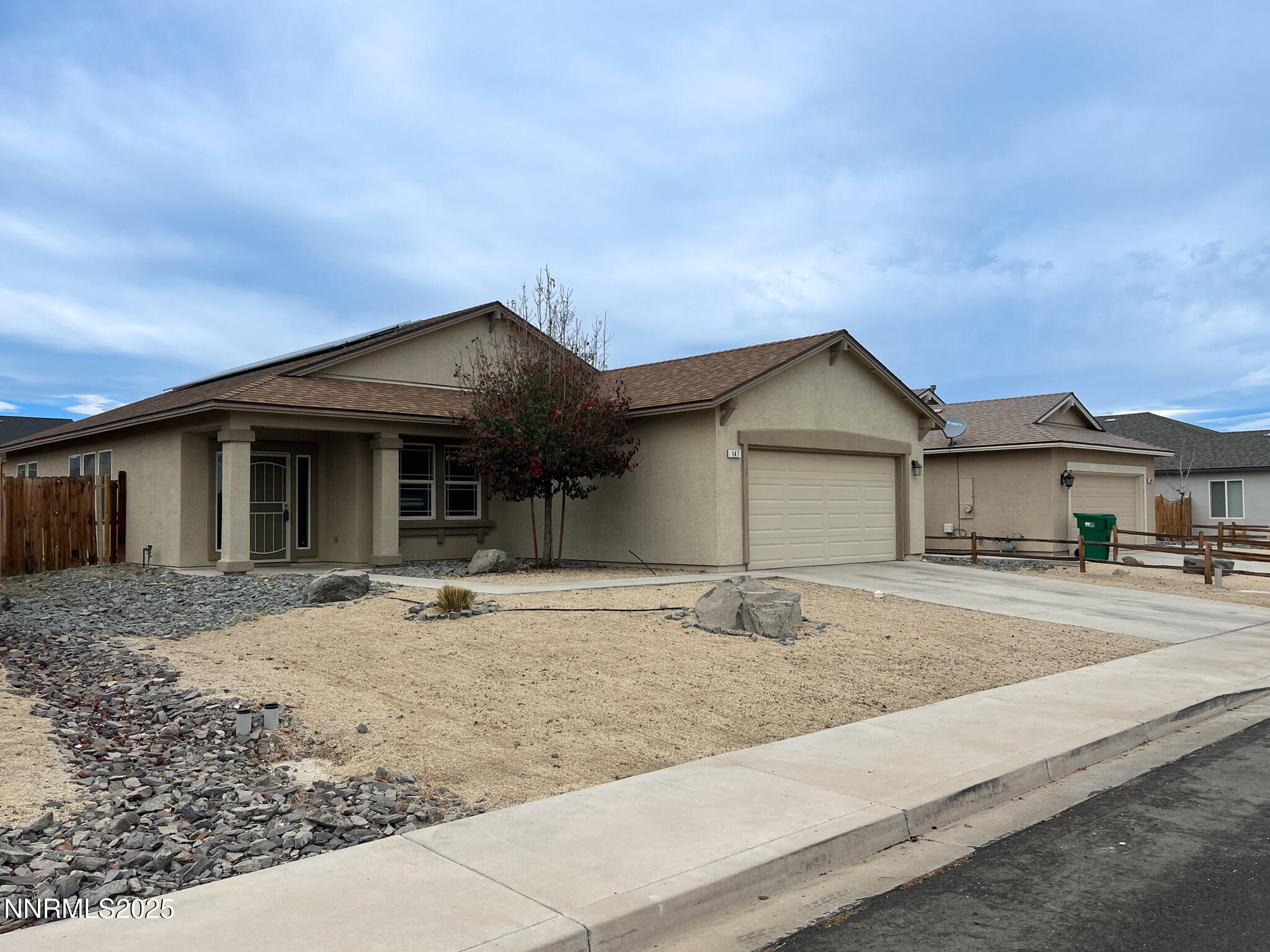 147 Walnut Drive Fernley, NV 89408 - Photo 2 of 31 a front view of a house with garden