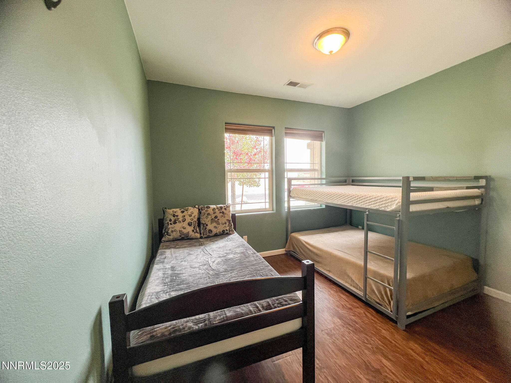 147 Walnut Drive Fernley, NV 89408 - Photo 21 of 31 a bedroom with a bed and wooden floor