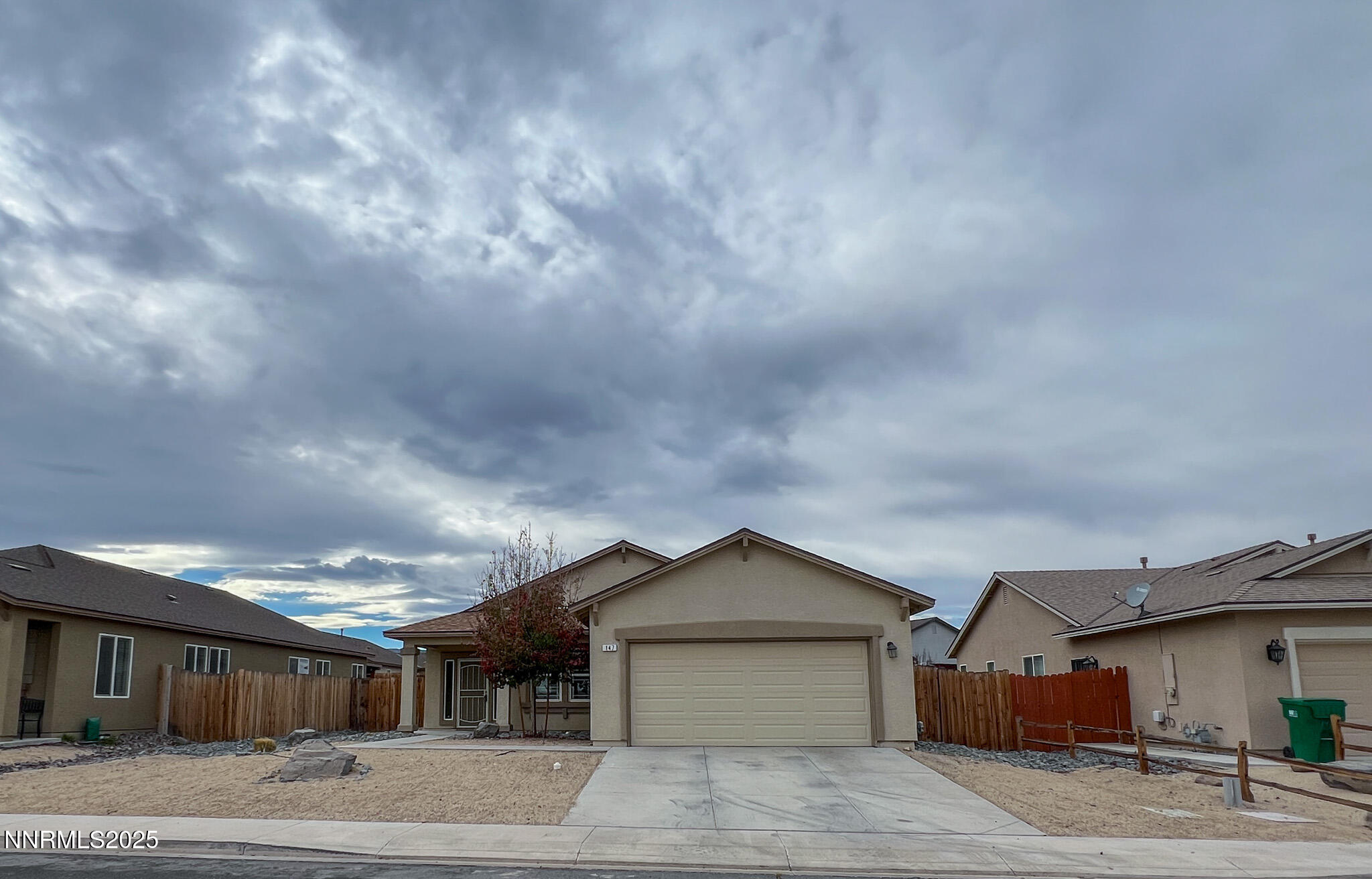 147 Walnut Drive Fernley, NV 89408 - Photo 27 of 31 a front view of a house with a yard and garage